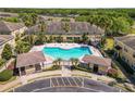 Aerial view of community pool area featuring palm trees and ample lounge seating at 5407 River Rock Rd # 5407, Lakeland, FL 33809