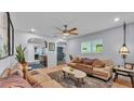 Cozy living room with a ceiling fan, an area rug and light blue walls with decorative archways at 5527 Flamingo Ave, Lakeland, FL 33809