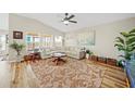 Cozy living room featuring a neutral sectional, hardwood floors, and bright natural light at 5543 Arlington River Dr, Lakeland, FL 33811