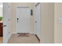 Inviting foyer featuring tile flooring, a welcome mat, and neutral paint at 6347 Torrington Cir, Lakeland, FL 33811