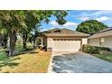 Charming home featuring a well-manicured lawn and a two-car garage, inviting curb appeal at 6775 Lake Clark Dr, Lakeland, FL 33813