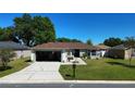 Well-maintained single-story home featuring a lush green lawn, driveway, and an attached garage at 8181 Bristol Bay Ave, Lakeland, FL 33810