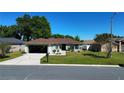 Well-maintained single-story home featuring a lush green lawn, driveway, and an attached garage at 8181 Bristol Bay Ave, Lakeland, FL 33810