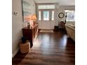 Welcoming foyer with wood floors, neutral walls, complemented by stylish furniture and decor, showcasing a bright entryway at 871 Thornburg Rd, Babson Park, FL 33827