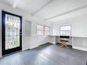 Bright, airy living room with hardwood floors, featuring a decorative door and a workspace with built-in shelving at 923 Lexington St, Lakeland, FL 33801