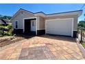 This single story home showcases a garage and unique brick paver driveway at 932 Augusta St, Lakeland, FL 33805