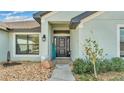 Inviting front entrance with decorative wreath, rock statue, and welcome decor at 955 Hunters Meadow Ln, Lakeland, FL 33809