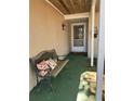 Cozy front porch featuring a bench with decorative pillows to sit and enjoy your morning coffee at 996 Willowbrook Ct, Winter Haven, FL 33884