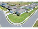 Aerial view of a suburban home with a spacious lawn, showcasing the neighborhood layout at 140 Heritage Park Ln, Mulberry, FL 33860