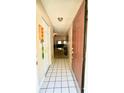 Inviting foyer with tile flooring and a view into the living spaces at 1618 Crystalview Trl, Lakeland, FL 33801