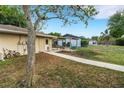Spacious backyard with a covered patio, perfect for outdoor entertaining and relaxation at 202 Saint Lucie Rd, Winter Haven, FL 33884