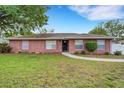Charming single story brick home with a well-manicured lawn and inviting walkway at 202 Saint Lucie Rd, Winter Haven, FL 33884