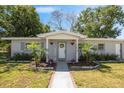 Inviting entryway with columns, decorative plants, and a welcoming sign, creating a warm ambiance at 2410 Nw Avenue B, Winter Haven, FL 33880