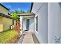 Charming home entrance featuring a covered porch and well-maintained landscaping at 6286 Manitoba Dr, Lakeland, FL 33805