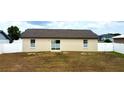 Backyard with a white vinyl fence providing privacy and security at 7968 Charleston Blvd, Lakeland, FL 33810