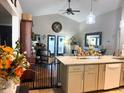 Bright kitchen with modern countertops, stainless steel appliances, and an open view to the living room at 811 W Heron Pl, Winter Haven, FL 33884