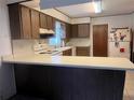 Cozy kitchen featuring wooden cabinets and a breakfast bar at 1528 Hallam S Ct, Lakeland, FL 33813
