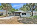 Charming home featuring a modern color scheme, screened porch and new landscaping at 1650 W Mcleod St, Bartow, FL 33830