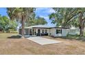 Charming single-story home with white facade, dark trim, and a welcoming screened-in porch at 1650 W Mcleod St, Bartow, FL 33830