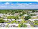 Expansive aerial view of a vibrant neighborhood showcasing lush greenery and community layout at 635 Cottage Ln # 635, Lakeland, FL 33803