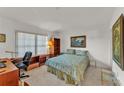 Cozy bedroom with a comfortable bed, a functional desk, and ample natural light at 7230 Hileman W Dr, Lakeland, FL 33810