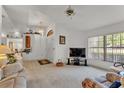 Bright living room boasting white walls, plush carpet, and an open layout at 7230 Hileman W Dr, Lakeland, FL 33810