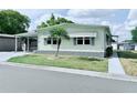 Well-kept single-story home with tidy landscaping, carport, and inviting facade at 1011 Pine Ridge Dr, Lakeland, FL 33809