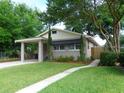 Charming single-story home with a well-manicured lawn and attached carport at 1014 Lexington St, Lakeland, FL 33801