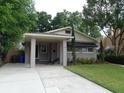 Charming single-story home featuring a covered entrance, well-maintained lawn, and mature trees at 1014 Lexington St, Lakeland, FL 33801