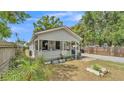 Charming single-story home with gray siding, inviting front porch with plants, and landscaped yard at 1105 Terry S Ave, Lakeland, FL 33815
