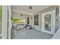 Inviting covered front porch with comfortable seating, gray wood deck, and decorative floral accents at 1105 Terry S Ave, Lakeland, FL 33815