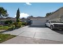 Charming home featuring an attached garage and long driveway at 1573 Avleigh Cir, Orlando, FL 32824