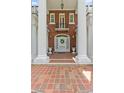 Inviting entrance with large white columns, beautiful brickwork, and a welcoming front door at 1760 Old Bartow Eagle Lake Rd, Bartow, FL 33830