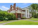 Beautifully landscaped brick home featuring large white columns and balconies on a sunny day at 1760 Old Bartow Eagle Lake Rd, Bartow, FL 33830