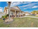 Landscaped front yard featuring a cozy porch with seating, showcasing a welcoming exterior and curb appeal at 1925 Binnacle St, Kissimmee, FL 34744