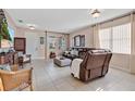 Bright living room featuring neutral walls, tile flooring, comfortable seating, and natural light from large windows at 1925 Binnacle St, Kissimmee, FL 34744