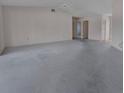Open-concept living area with neutral carpeting, light walls, and multiple entryways for optimal flow at 2085 Long Boat Dr, Lakeland, FL 33810