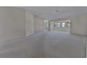 Spacious living room features neutral carpeting, light walls, and a ceiling fan at 2085 Long Boat Dr, Lakeland, FL 33810