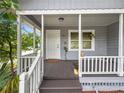 Inviting covered front porch with white railing, space to relax, and decorative plants at 219 Ariana St # A-B, Lakeland, FL 33803