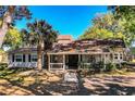 Inviting home featuring a cozy front porch with a seating area, enhancing curb appeal at 2319 D R Bryant Rd, Lakeland, FL 33810