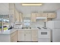 Bright kitchen featuring white appliances and ample counter space at 2511 Limewood Ave, Clermont, FL 34714