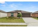 Charming single-story home with a well-manicured lawn, complemented by a two car garage and beautiful landscaping at 2726 Red Egret Dr, Bartow, FL 33830
