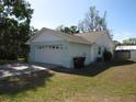 Features a two-car garage and a tidy lawn, complemented by a neatly arranged set of trash receptacles at 281 Glenridge S Loop, Lakeland, FL 33809