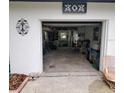 Spacious garage providing ample storage and workspace with visible organizational solutions and natural light at 308 Ne 10Th Ave, Mulberry, FL 33860