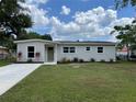 Inviting single-story home with a lush lawn, refreshed exterior paint, and modern landscaping at 3227 Decatur Ave, Lakeland, FL 33805
