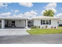 Well-maintained single-story home with a covered carport and lush green lawn at 3570 Milano Ave # 3570, Lakeland, FL 33803