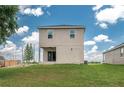 A spacious backyard featuring a covered patio, a well-maintained lawn and a freshly planted tree at 4189 Radford Rd, Bartow, FL 33830