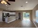 Open concept kitchen with stainless steel appliances, center island, and sliding glass doors to the backyard at 4189 Radford Rd, Bartow, FL 33830