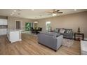 Open-concept living area with wood-look flooring, comfortable seating, and ample natural light at 4189 Radford Rd, Bartow, FL 33830