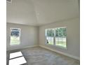Spacious bedroom with two windows allowing natural light and wood look tile flooring throughout at 4318 Juliana Lake Dr, Auburndale, FL 33823